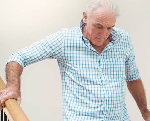 Man confidently using stairs after Neuro-Balance Therapy